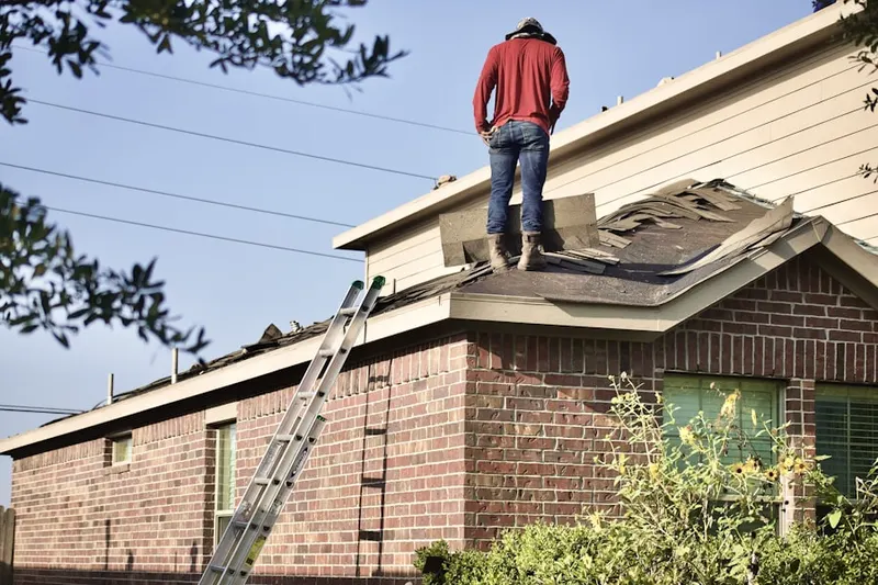 Professional roofer working on a residential roof in Repaupo